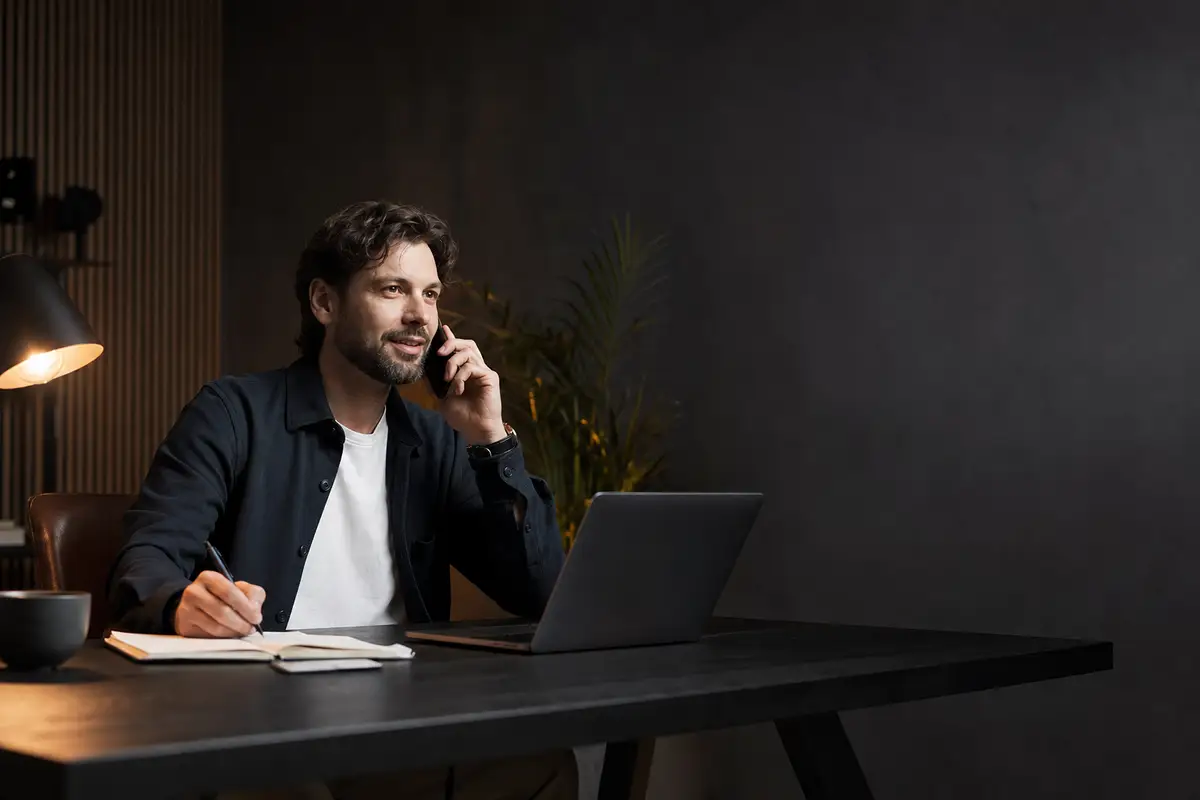 Agency owner planning client growth work at a desk